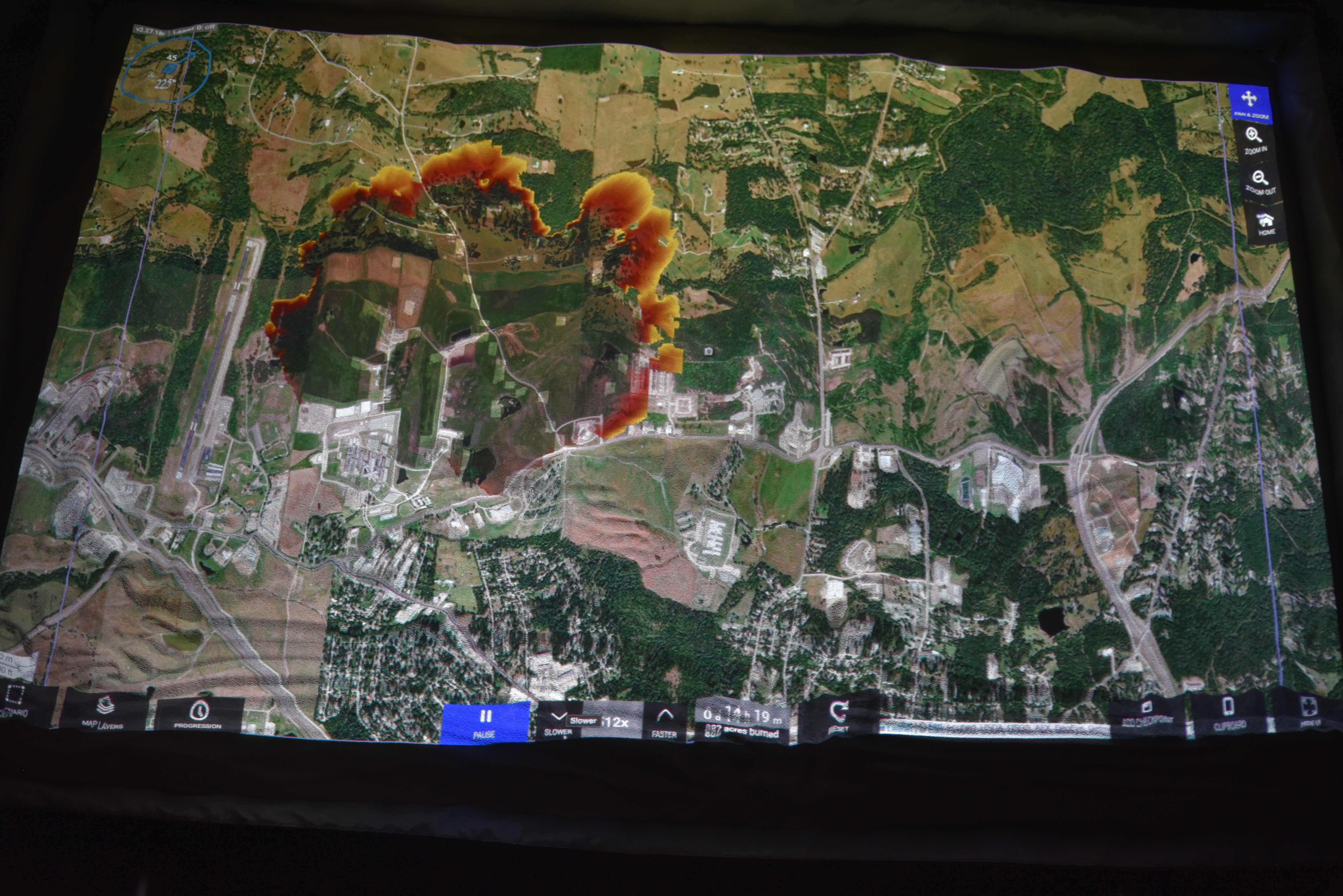SimTable display showing a wildfire spreading out from a center.