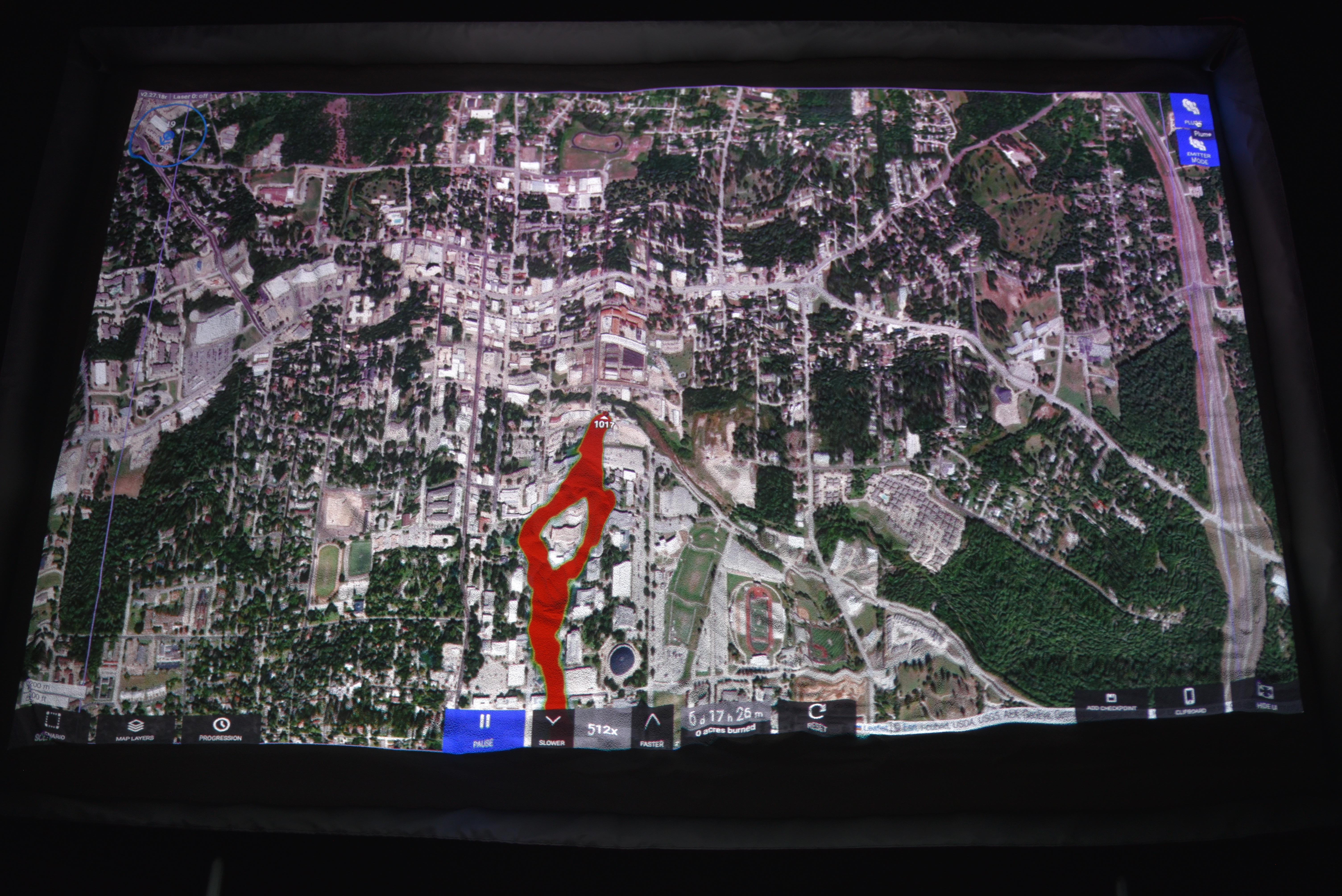 SimTable display showing a chemical plume spreading out from a single location blowing in the wind.